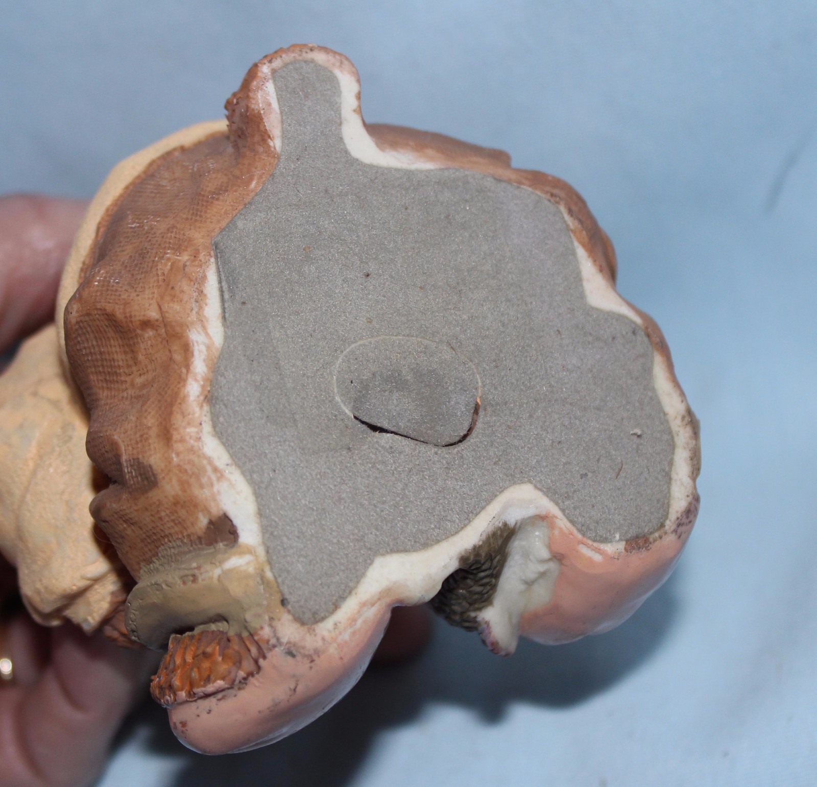 Bear figurine with fish and paddle. Hoodie w/ letter A