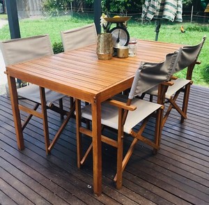 outside timber table with 4 grey deck chairs outdoor
