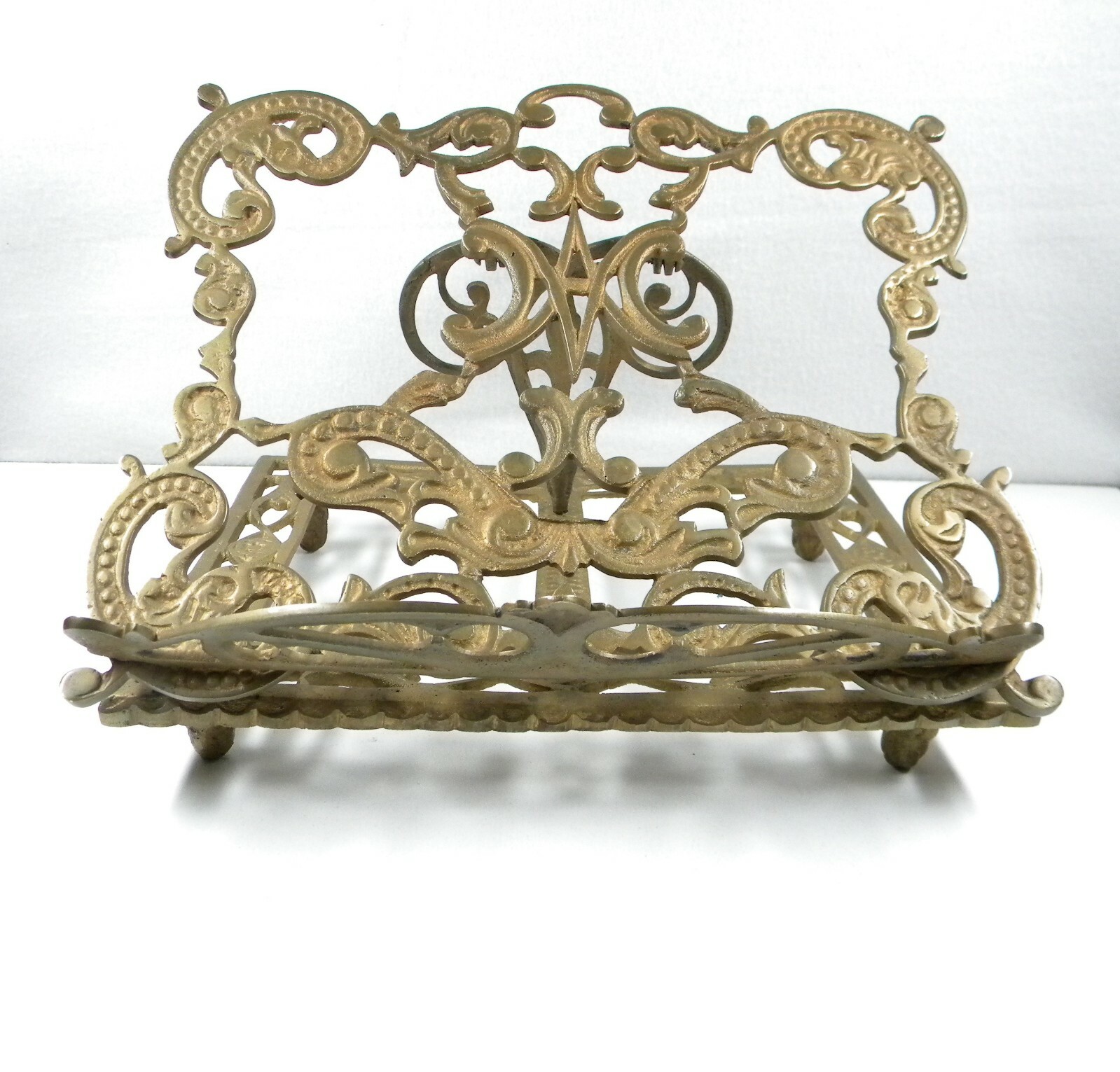 Cast brass book stand.