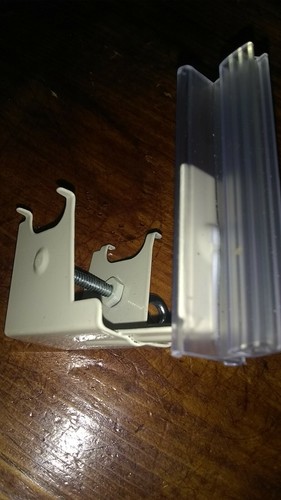 Under shelf spring mount super grip sign holder