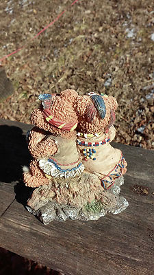 Adorable bear boy and girl dressed as indians figurine