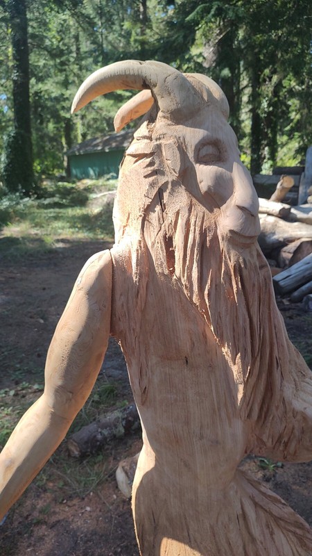 chainsaw carving wood sculpture. 5 foot tall Satyre carved out