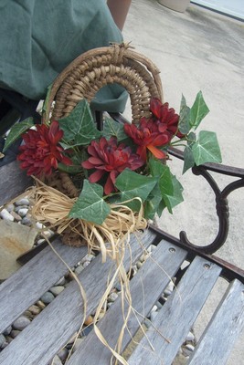 Hanging straw basket, Small decorative red mum arrangement.