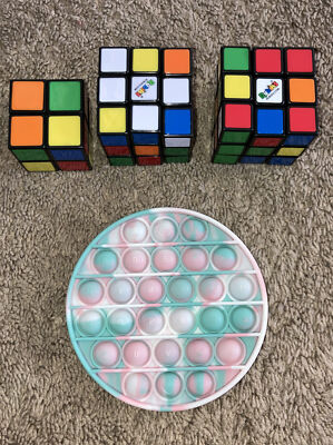 Lot Of 4 Fidget Toys - Two 3x3 Rubix Cubes, One 2x2 Rubix Cubes, One Pop It Toy