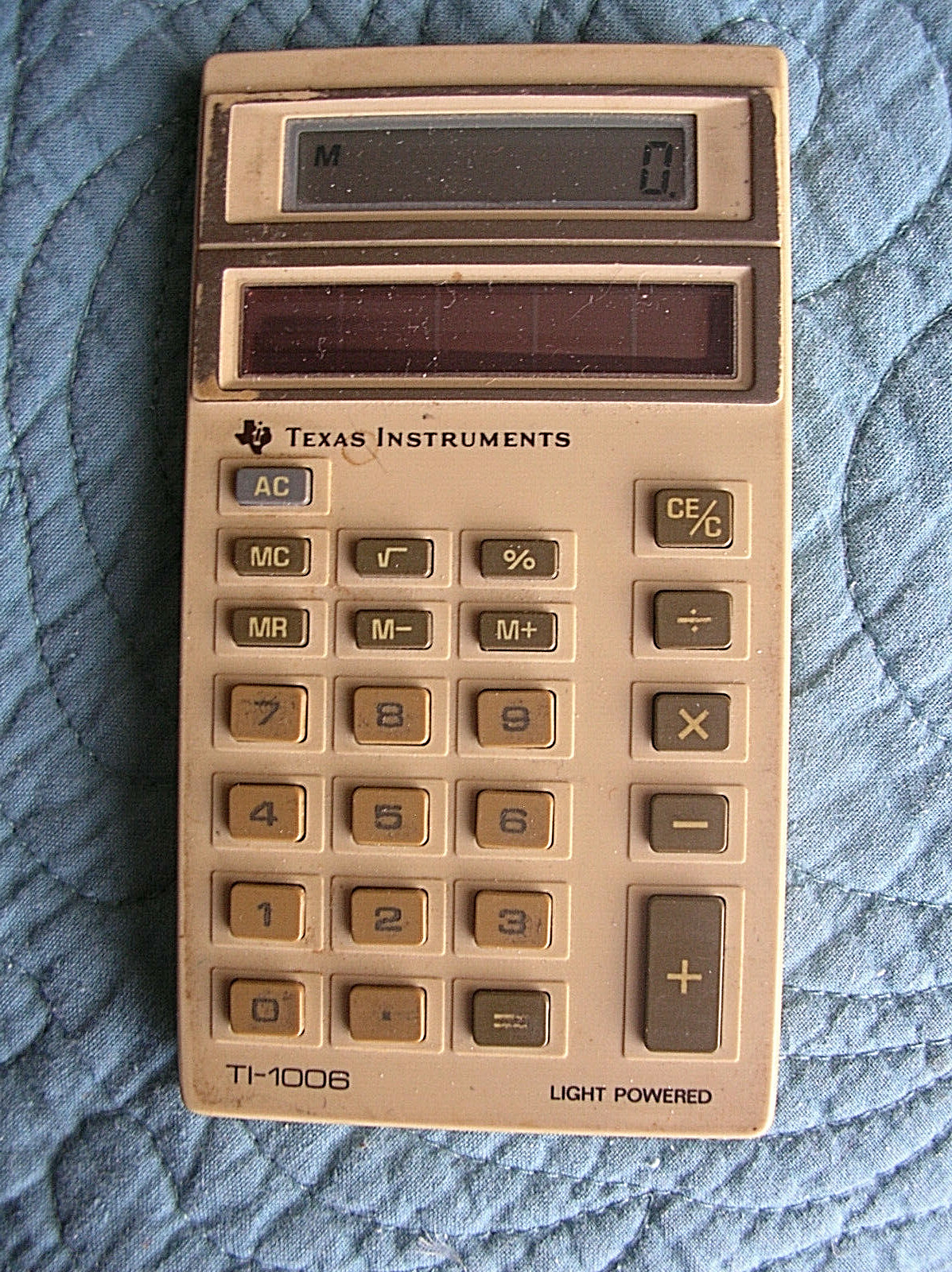 Two Texas Instrument calculators, Ti-31 and Ti-1006.