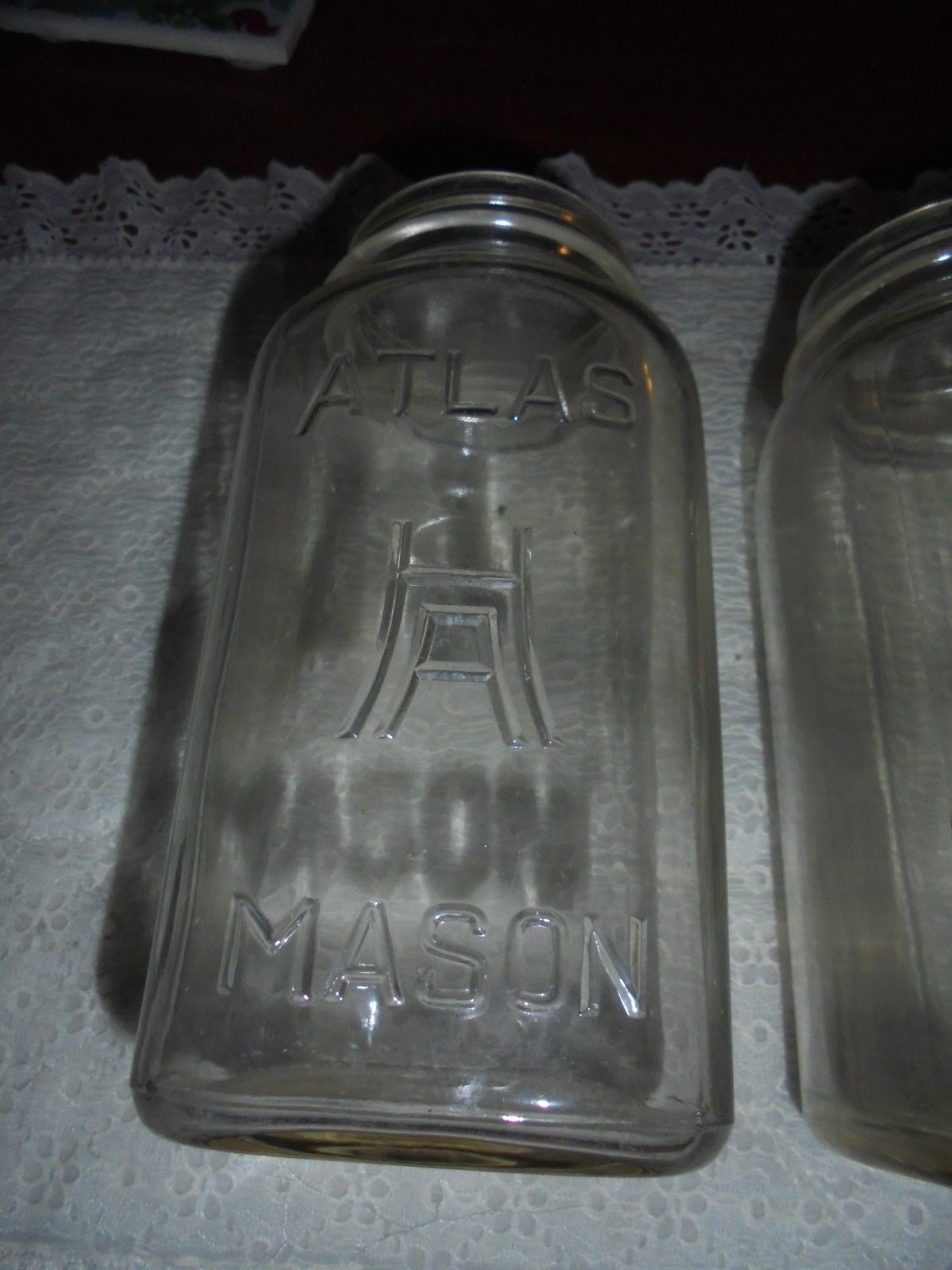 Four vintage square ATLAS MASON quart size clear jars, large H over A