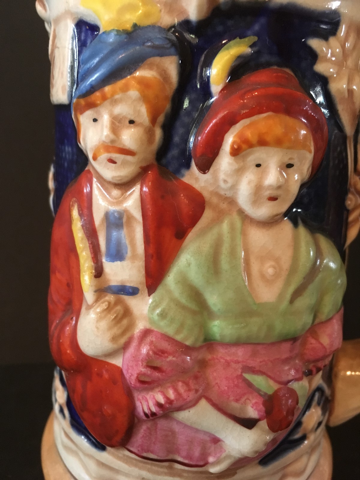 vintage stein hand painted rised man and lady on base