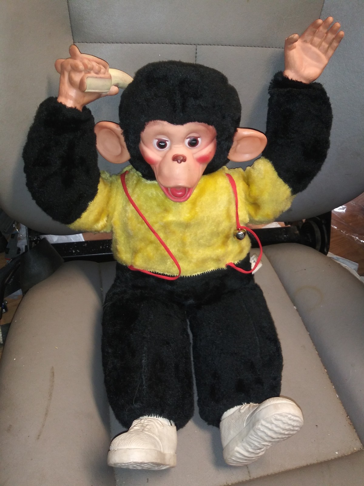 old stuffed monkey with banana in hand