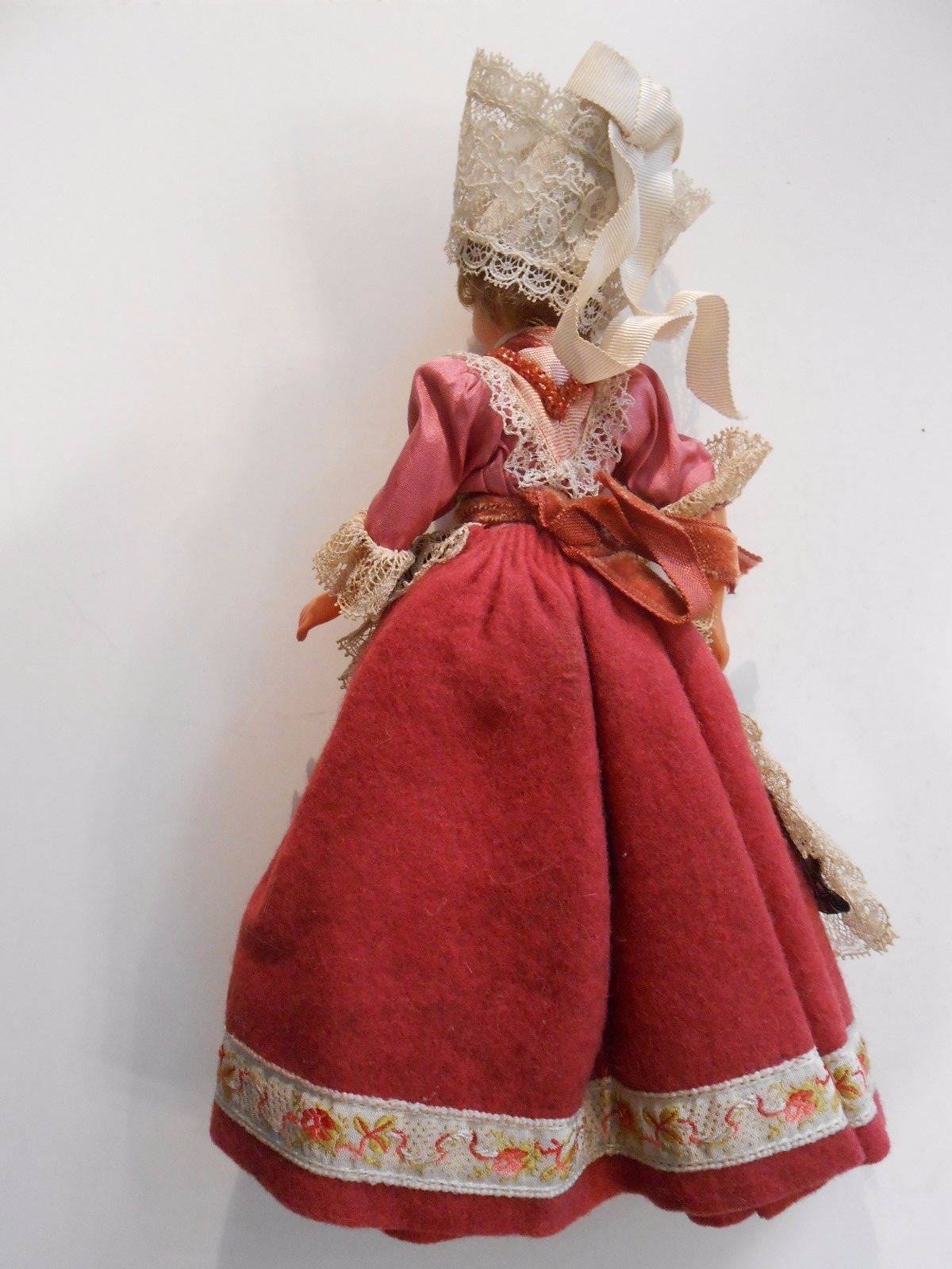 1950's era souvenir doll from Unknown Country. Wearing a cross around her neck.