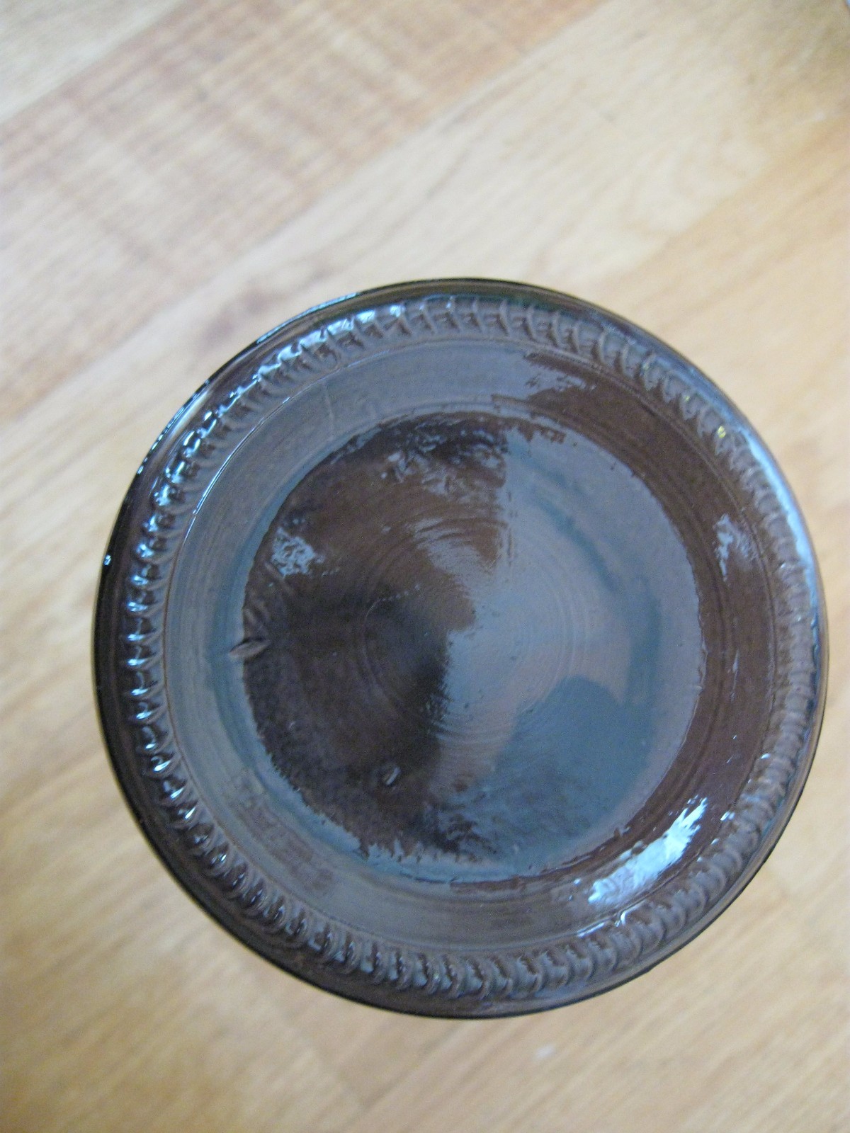 Finely Ground Raven Claws Label on a Corked and Sealed SmokeColored Empty Bottle