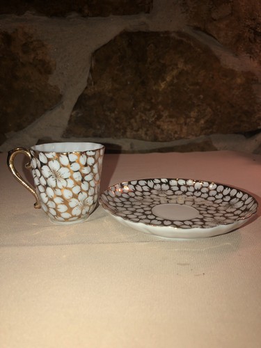 Tea Cup & Saucer gold with white flowers.