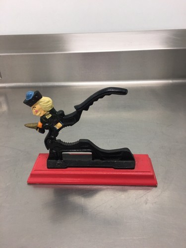 CAST IRON NUTCRACKER, SOLDIER ON RED WOOD BASE