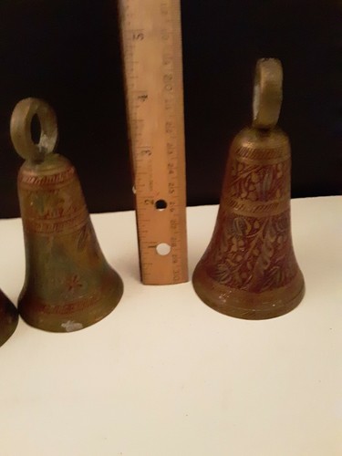 Five ornate engraved brass bells colored