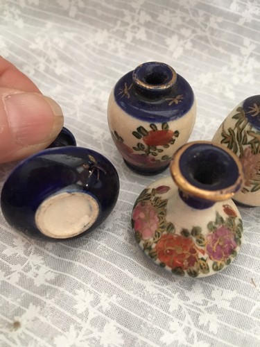 4 miniature porcelain pieces. Cobalt blue with flowers hand painted.  Two vases