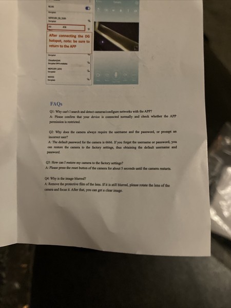 Blurred FAQ document on table.