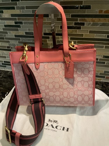 This is a（n） Base Field Tote Tall Coach Field Tote Bag In Signature Coated Canvas With Big