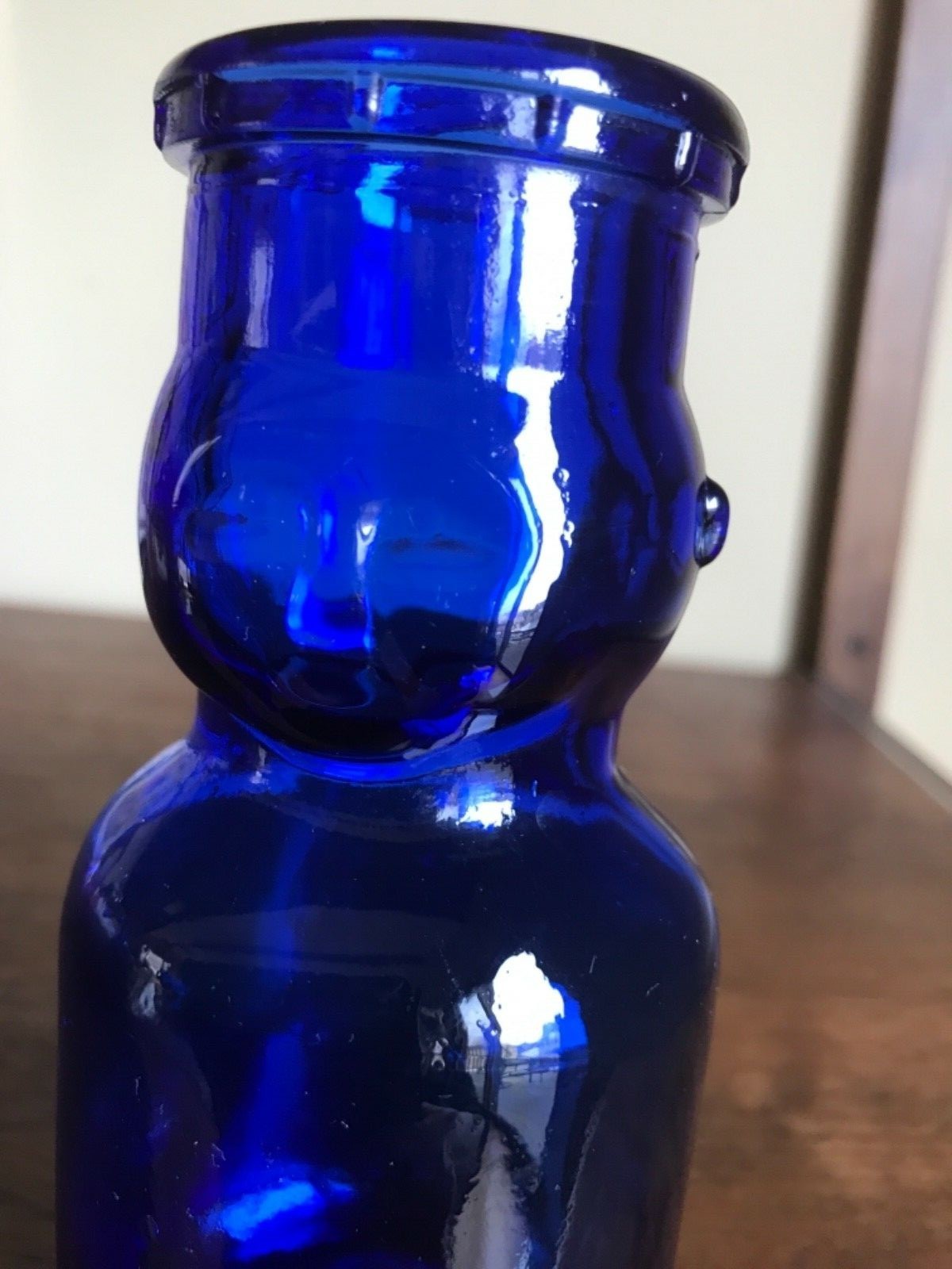 Vintage  BABY FACE HALF PINT MILK BOTTLE. Blue glass