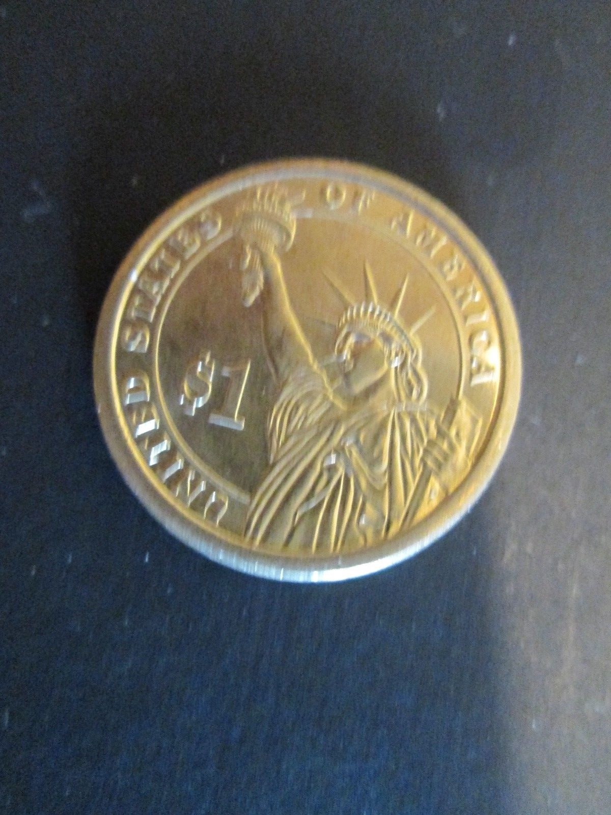 Gold colored $1.00 coin - John Quincy Adams