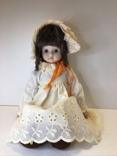 porcelain doll, 14 inches, brown hair& eyes. made