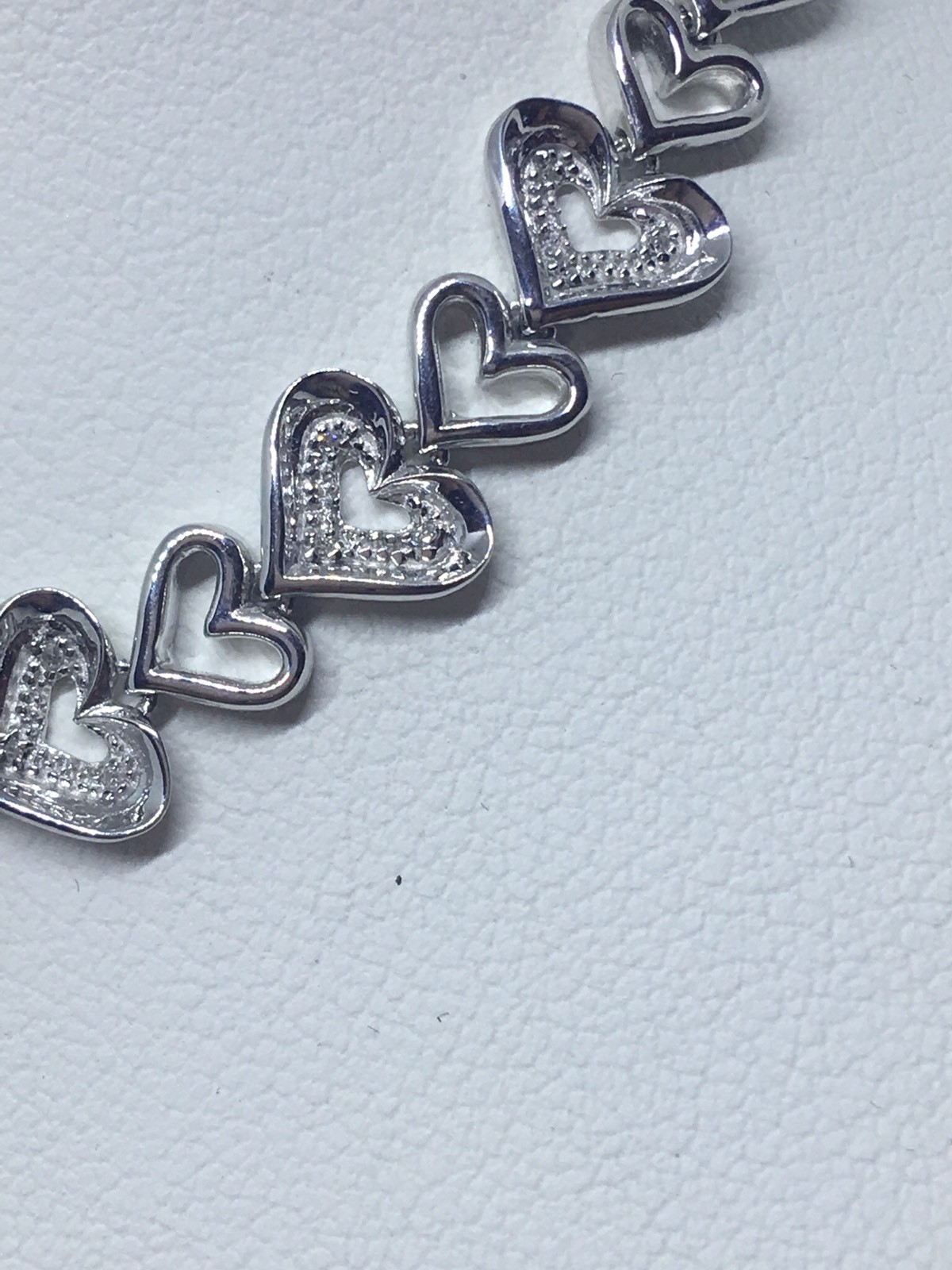 Zales 1/10 CT. T.W. Diamond Tilted Heart Link Bracelet in Sterling Silver