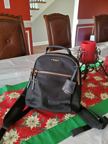 tumi black and gold backpack