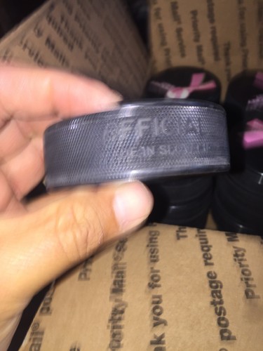 Hockey East  Hockey Pucks New  Lot Of 34  In glas  Official  Pink