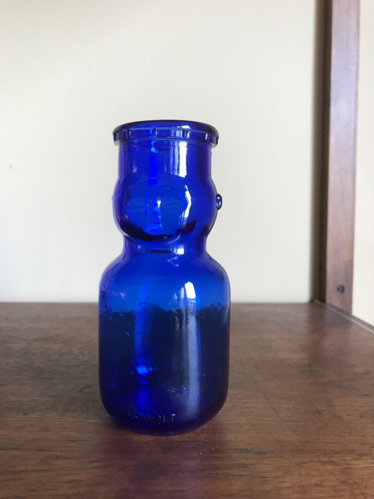 Vintage  BABY FACE HALF PINT MILK BOTTLE. Blue glass