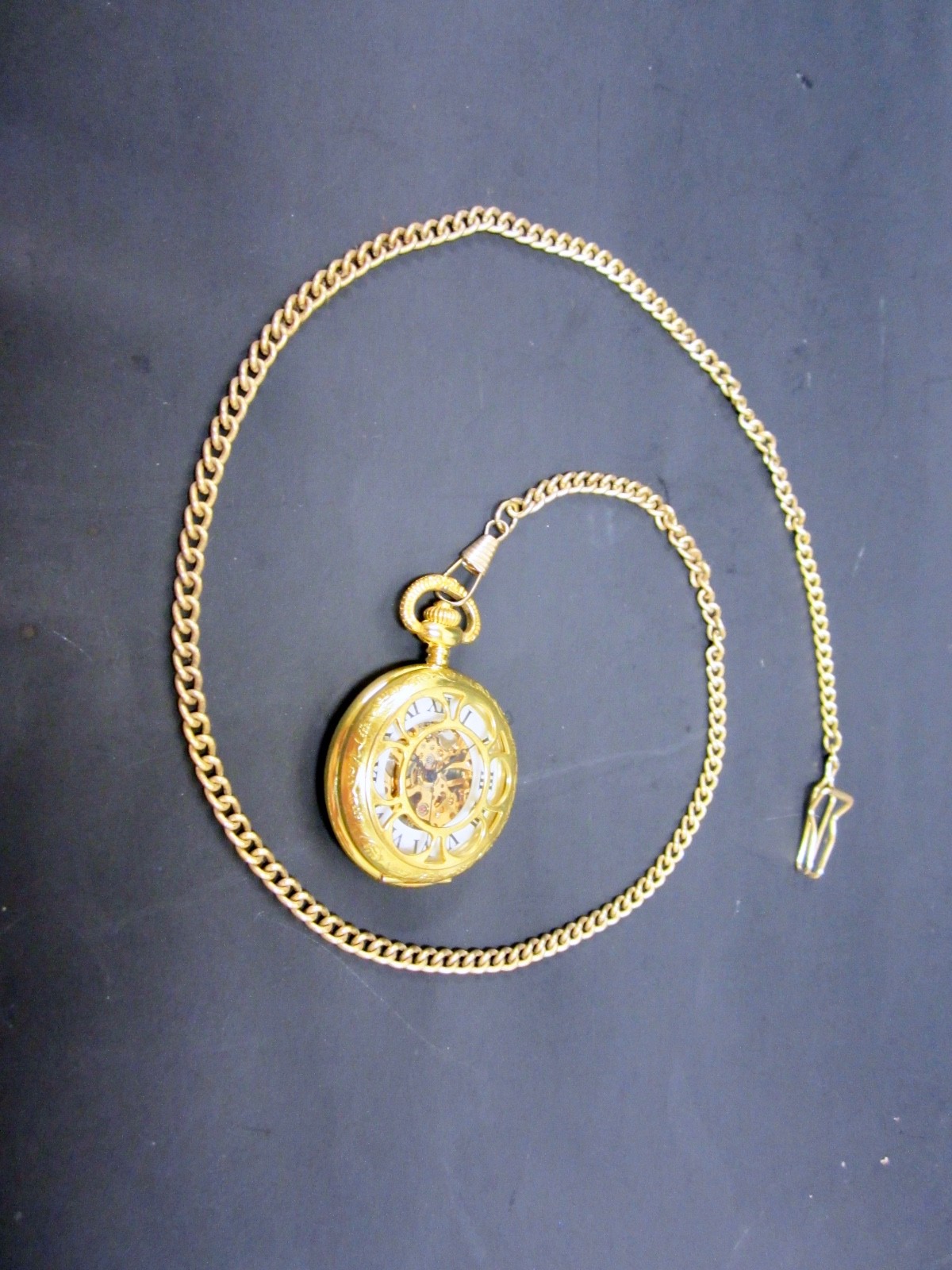 beautiful wind up pocket watch with cutouts brass? Gold filled? No brand