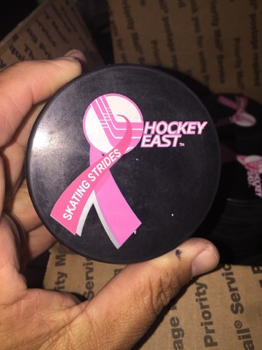 Hockey East  Hockey Pucks New  Lot Of 34  In glas  Official  Pink