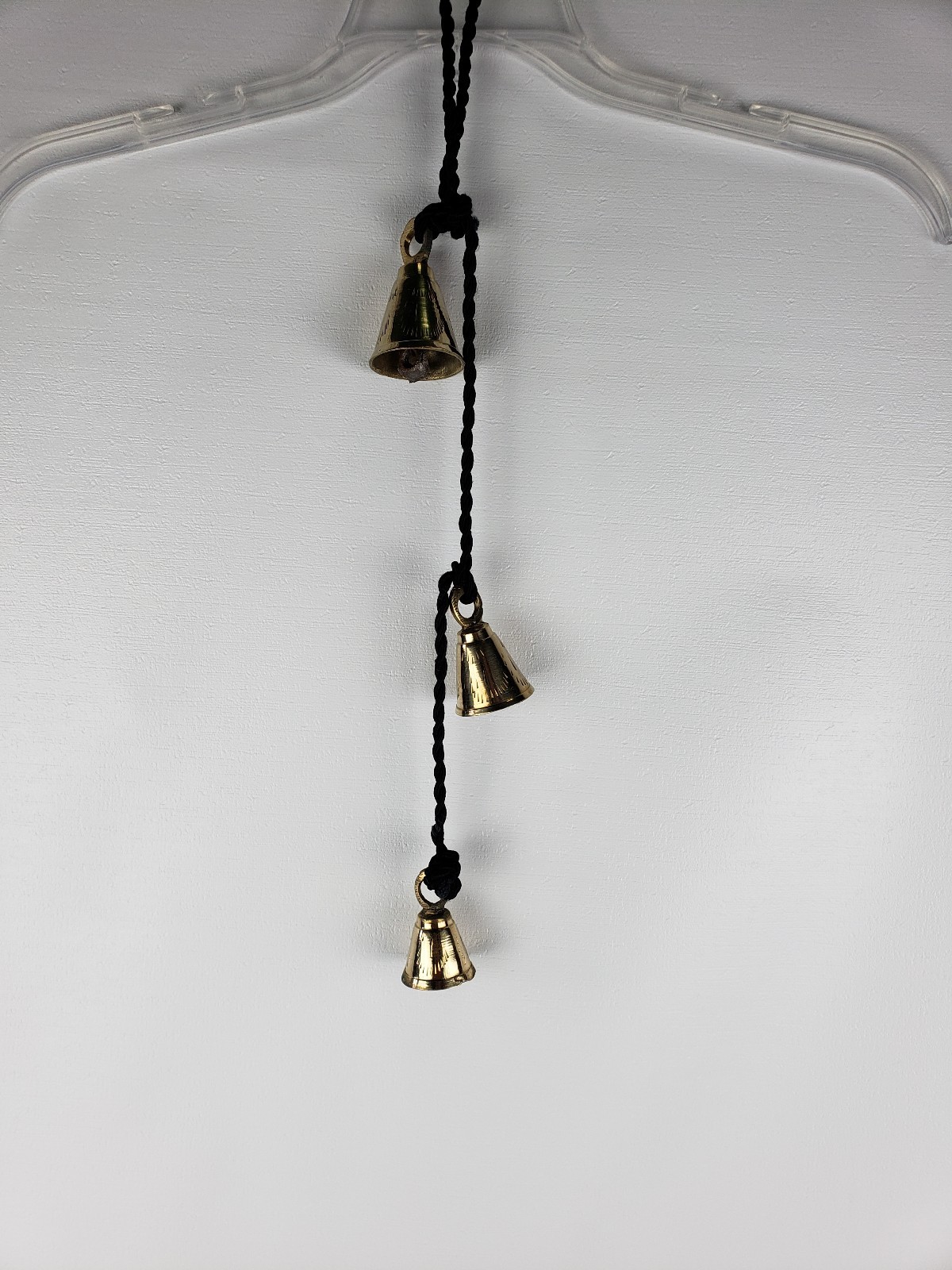3 Brassy Bells Strung on a Black Rope India Same Shape Different Sizes