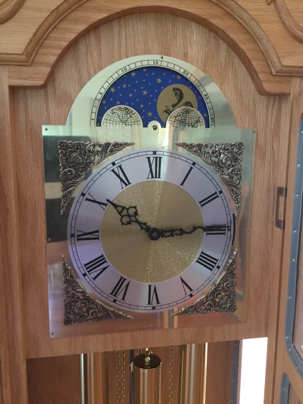 Grandfather  clock. Howard Miller. Light oak.