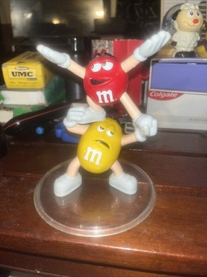 Red And Yellow M&M Figurine Balancing 