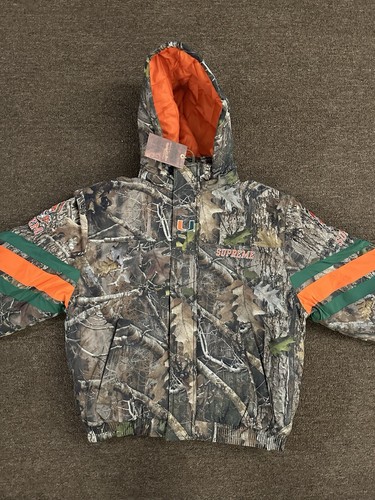 SUPREME SUPREME MITCHELL & NESS NCAA HOODED STADIUM JACKET WOODLAND CAMO SMALL CONFIRMED