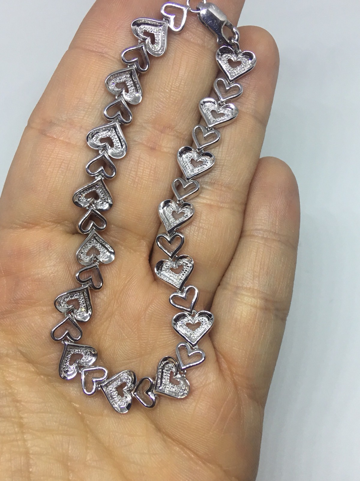 Zales 1/10 CT. T.W. Diamond Tilted Heart Link Bracelet in Sterling Silver