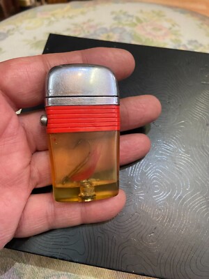 Scripto vintage lighter with fish hook lure Vu circa 1960's worn but nice red