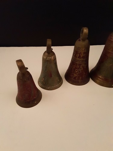 Five ornate engraved brass bells colored