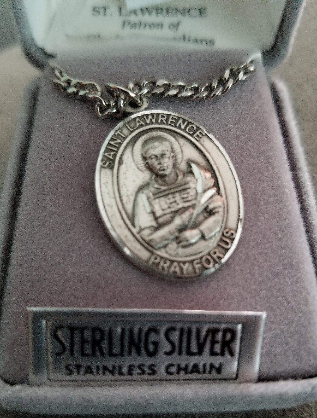 St. Lawrence sterling silver with 24" stainless steel chain