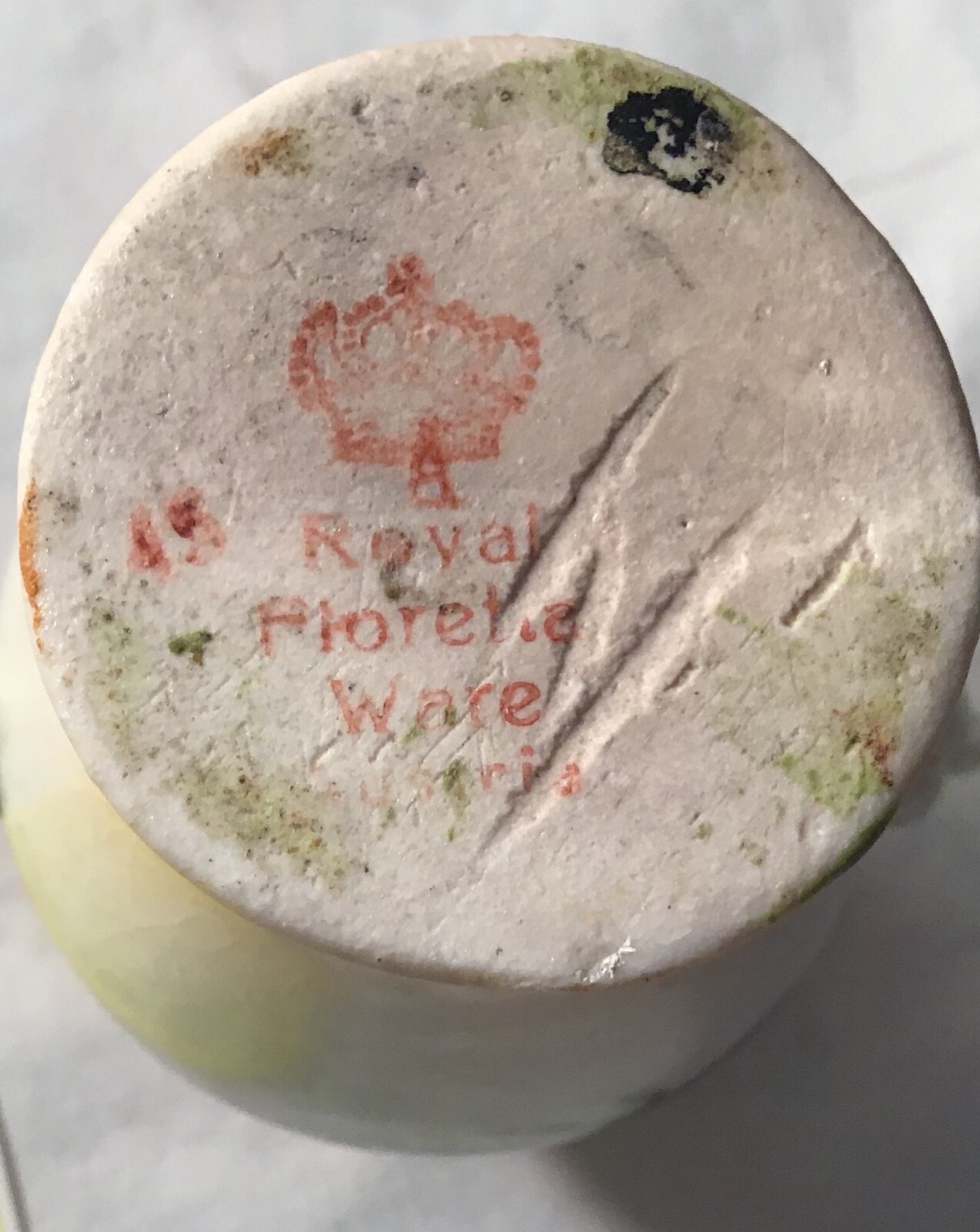 Antique vase with yellow flowers with Crown on bottom