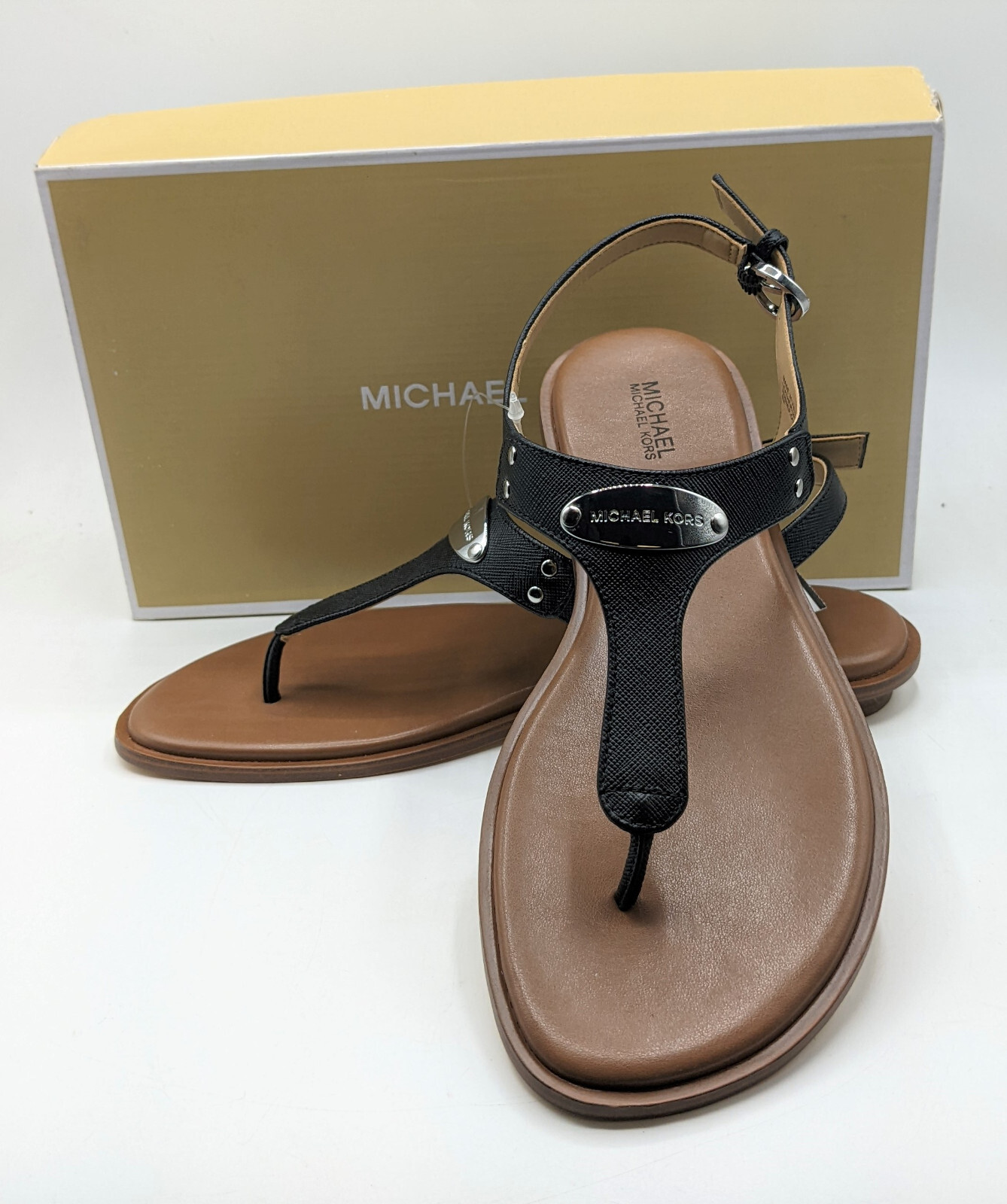 Michael Kors Women's Logo MK Plate Thong Leather Flat Sandal Michael Kors Women's Logo MK Plate Thong Leather Flat Sandal