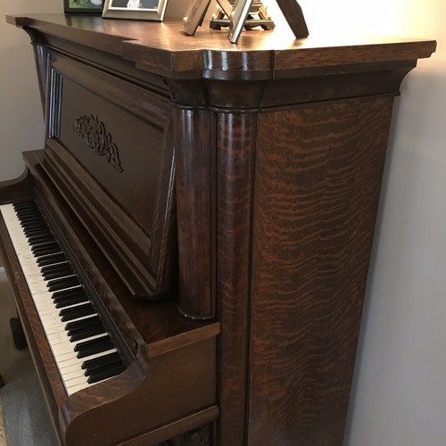 Oak Empire Revival style upright piano by the Beckwith Piano Company