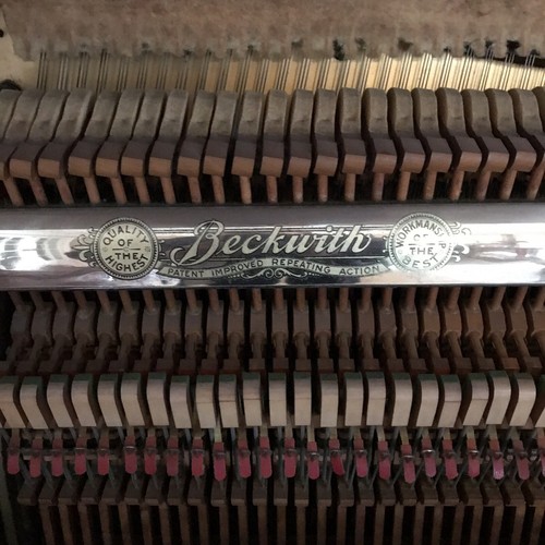 Oak Empire Revival style upright piano by the Beckwith Piano Company