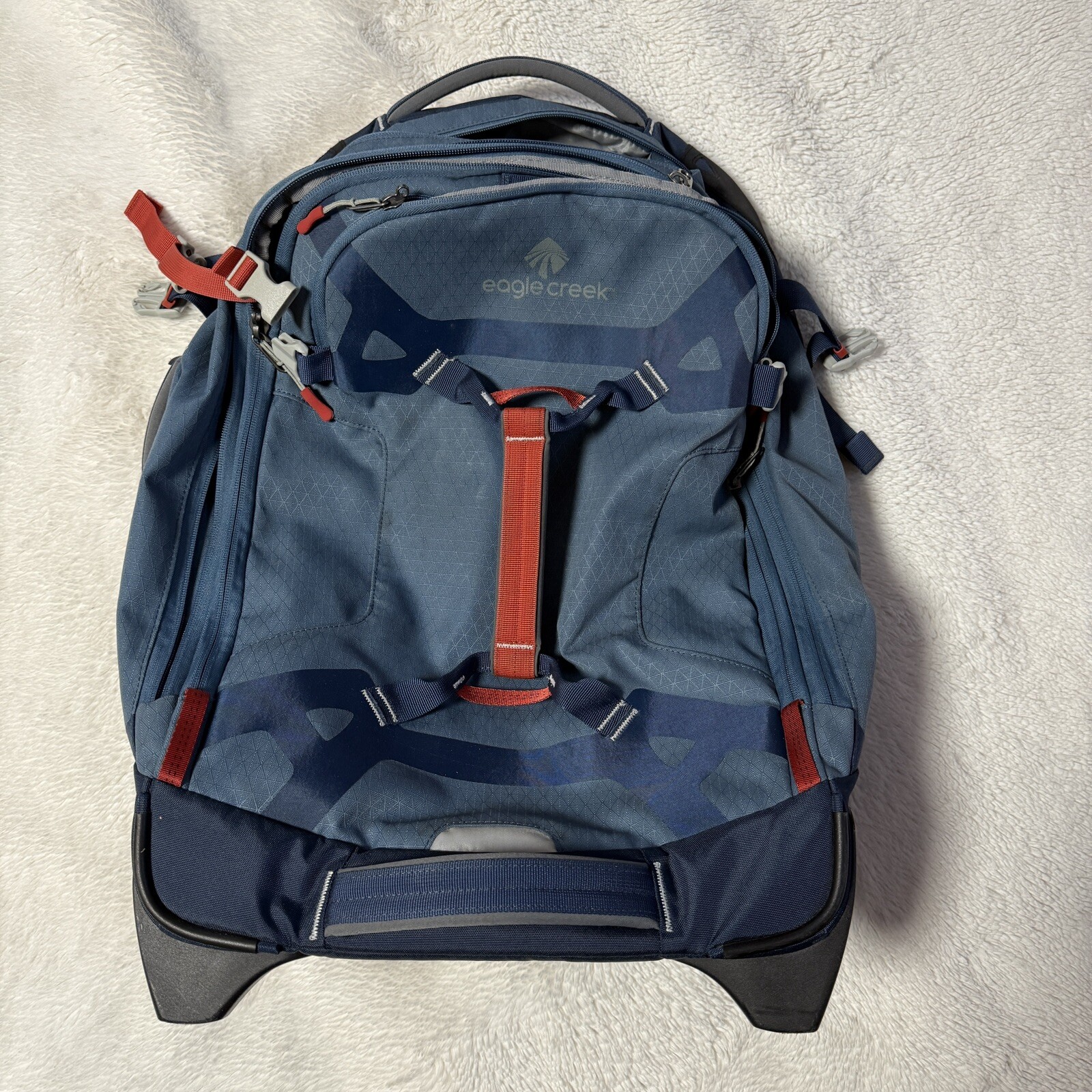 Angled front view with bag zipped and handles upright.