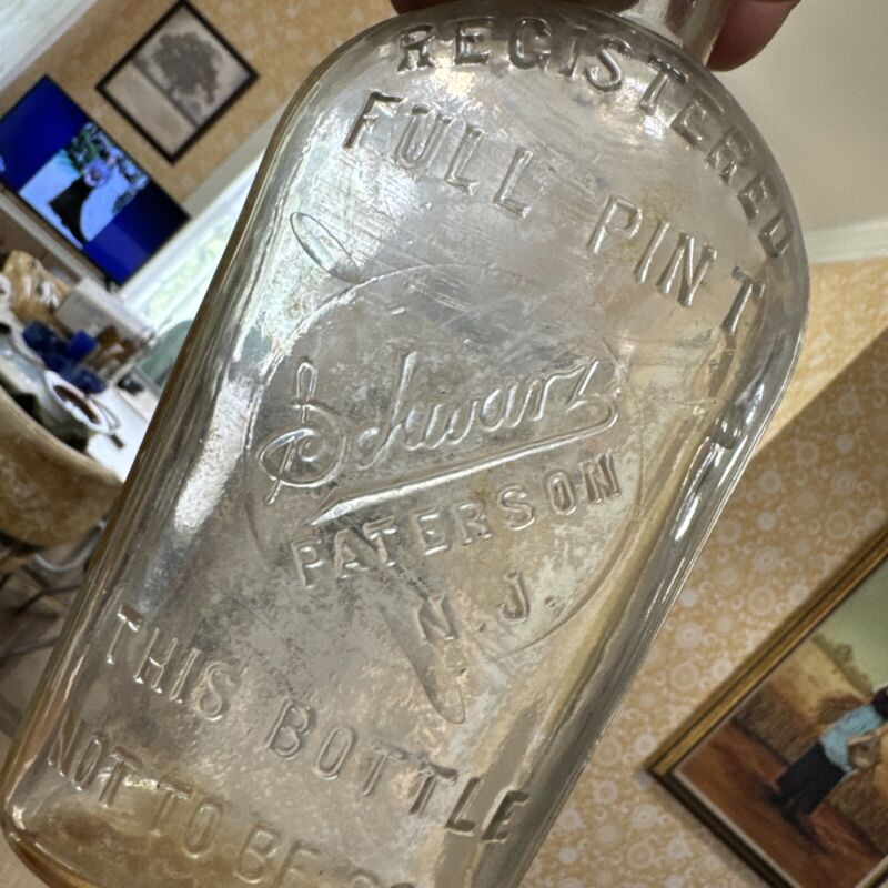vintage embossed slug plt Schwartz Paterson NJ whiskey bottle 