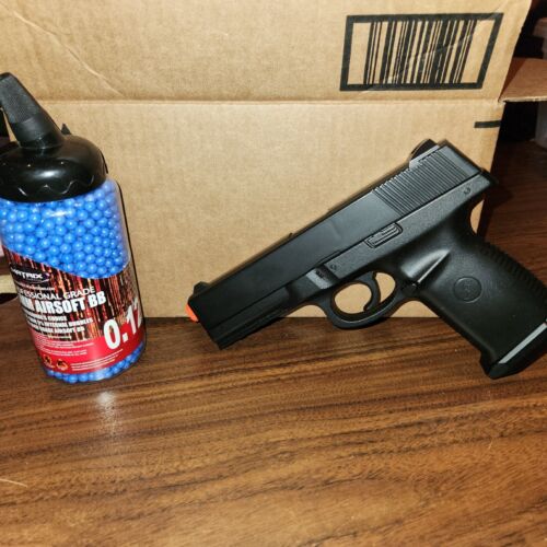 Airsoft glock pistol and container of airsoft bbs, spring lo