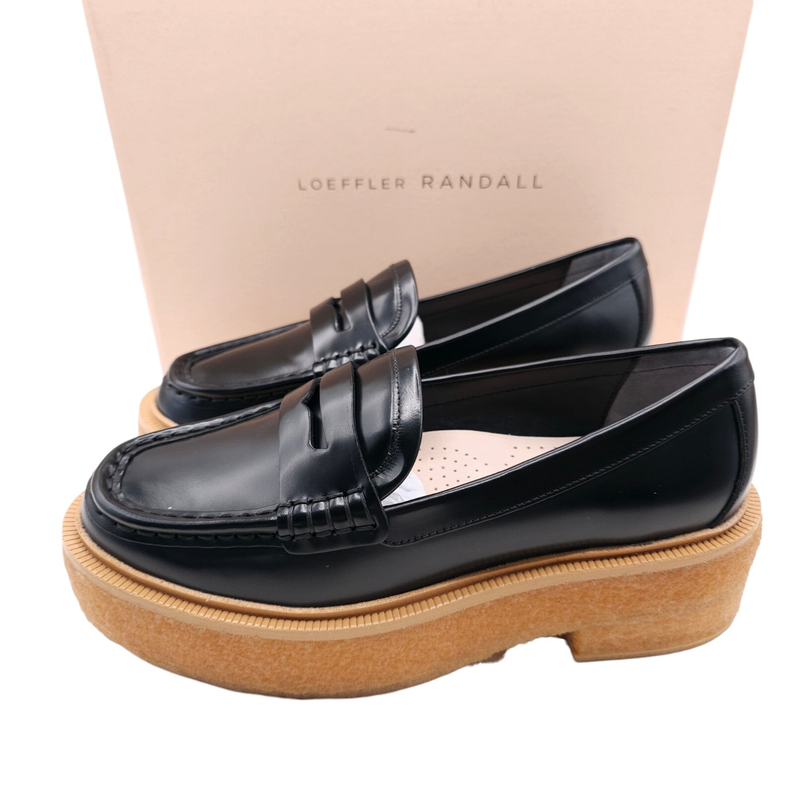 Angled front view with bag zipped and handles upright.