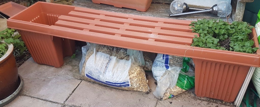 useful garden seat with planter at each end. teracotta