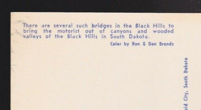 Pigtail Bridge in the Black Hills of South Dakota shows older station wagon car