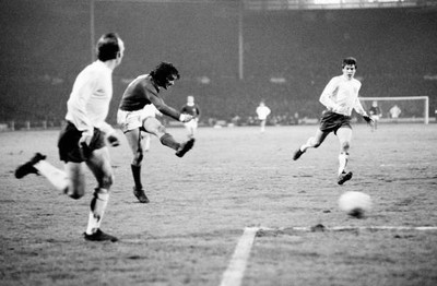 George Best shoots watched by England defenders Nobby Stiles and E- Old Photo