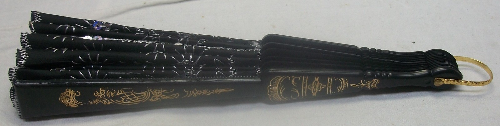 EMBROIDERED BLACK FABRIC W/ SEQUINS, BLACK PLASTIC RIBS,  FOLDING HAND HELD FAN