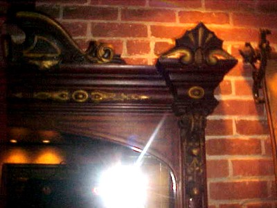 ANTIQUE EAST LAKE MIRROR, SURRONDED BY HAND CARVED WALNUT ORNATE FRAMING